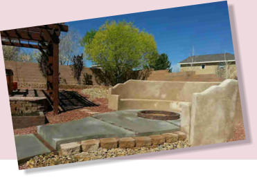 Concrete walkway and gathering area around fire pit and bancos  by Rising Sun Landscaping & Maintenance