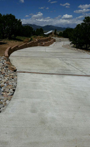 Long concrete driveway, landscaping, by Rising Sun Landscaping & Maintenance