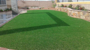 Synthetic lawn, artificial turf in back yard landscaping by Rising Sun Landscaping & Maintenance