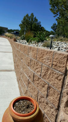 Retaining wall and walkways are benefits in landscaping.